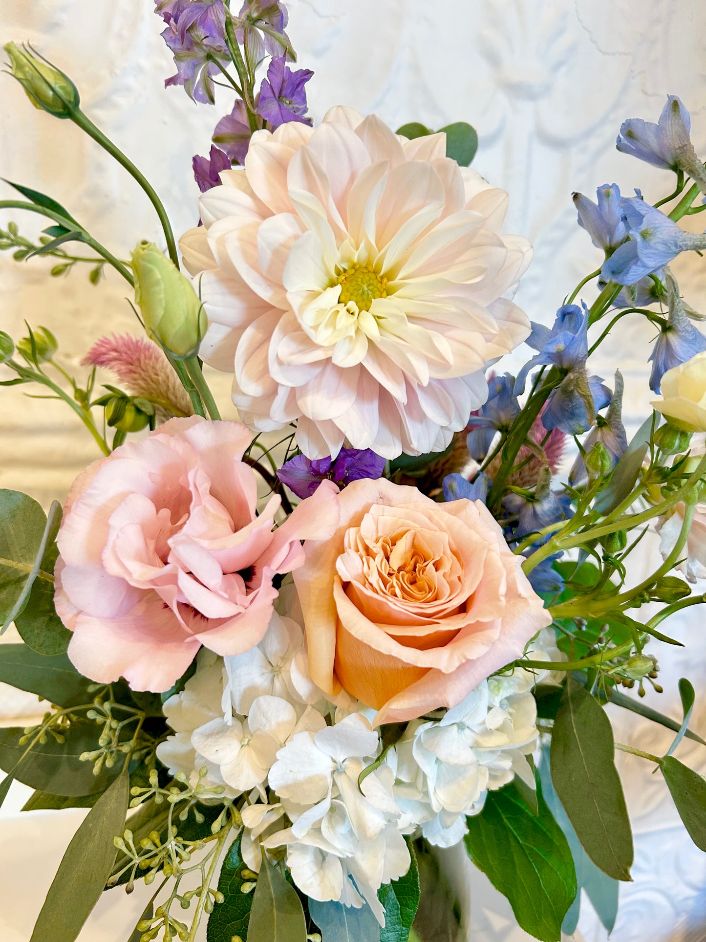 Bouquet of flowers including roses and hydrangeas with a soft focus background