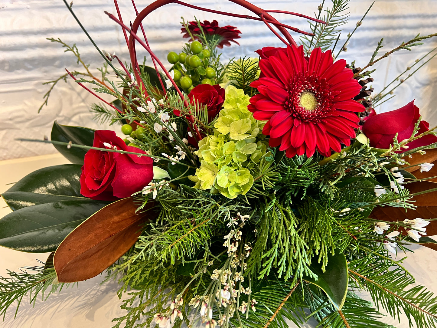 Holiday Arrangement with Winter Greens and Roses