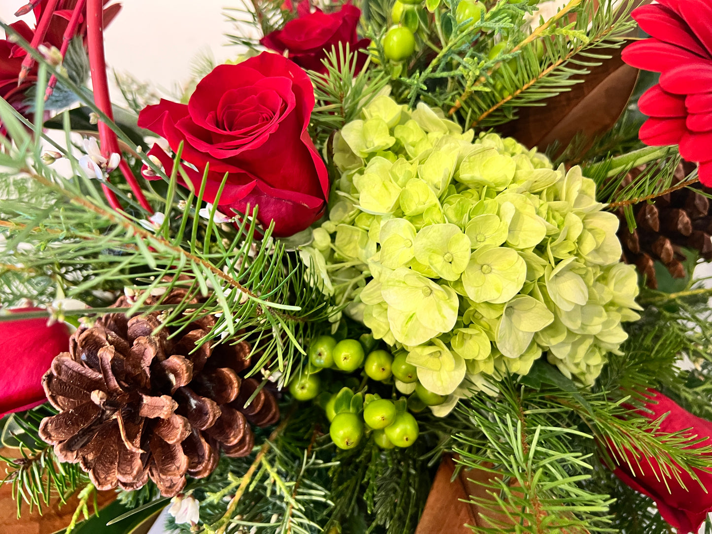 Holiday Arrangement with Winter Greens and Roses