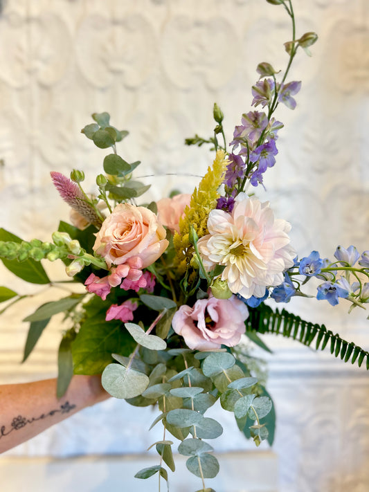 Bouquet of flowers held by a person with a blurred background