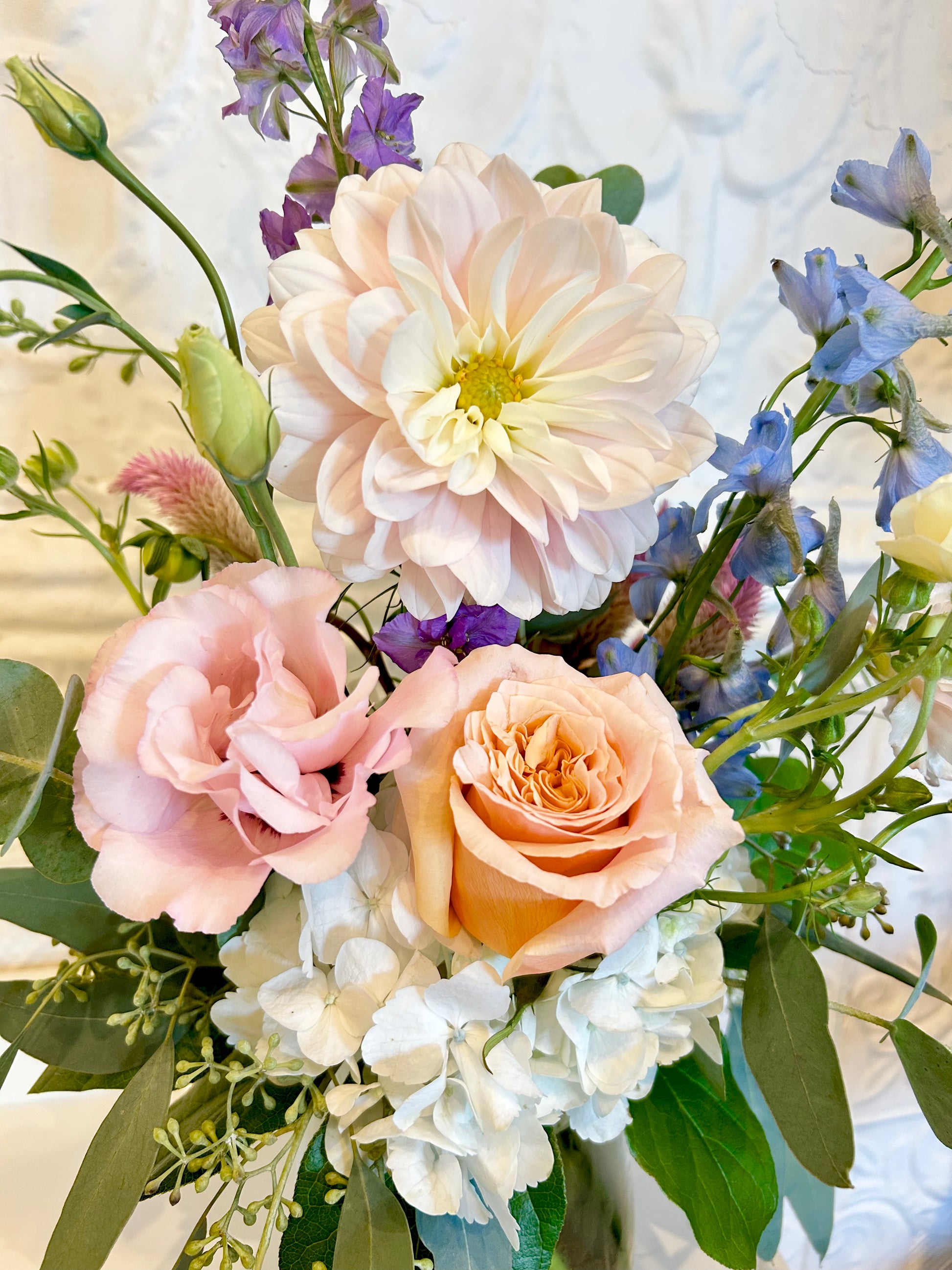 Bouquet of flowers including roses and hydrangeas with a soft focus background